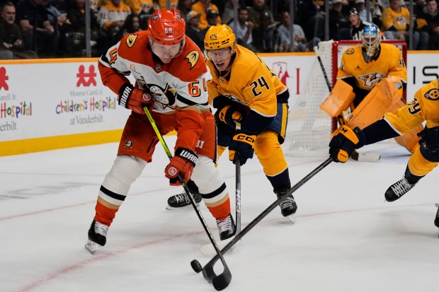 Ducks center Mikael Granlund (64) and Nashville Predators defenseman Spencer...