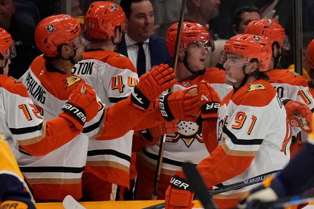 Ducks center Leo Carlsson (91) celebrates his goal with teammates...