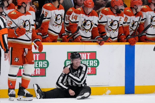 Linesman Joe Mahon (89) sits on the ice injured during...
