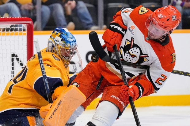 Ducks center Mason McTavish (23) collides with Nashville Predators goaltender...