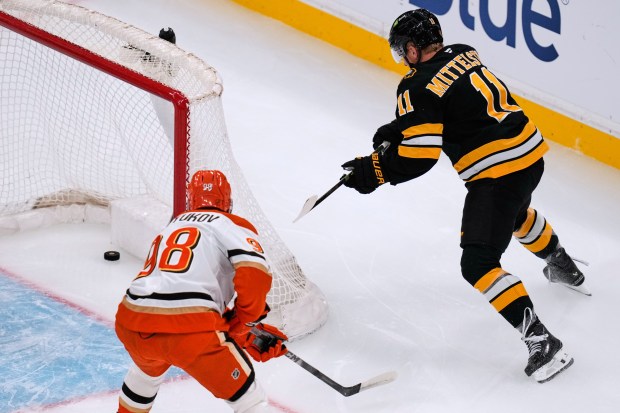 Boston Bruins center Casey Mittelstadt (11) scores in front of...