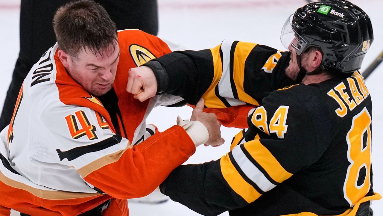 Boston Bruins left wing Tanner Jeannot (84) lands a punch in a fight against Anaheim Ducks left wing Ross Johnston (44) during the second period of an NHL hockey game, Thursday, Oct. 23, 2025, in Boston. (AP Photo/Charles Krupa)