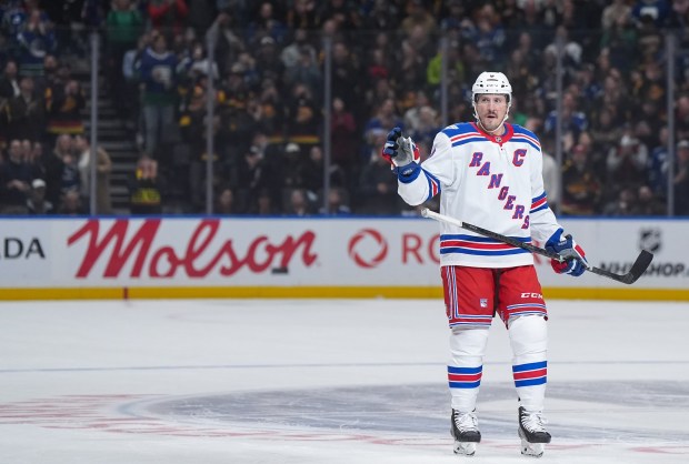 New York Rangers' J.T. Miller acknowledges a standing ovation from the crowd during the first period of an NHL hockey game against his former team, the Vancouver Canucks, in Vancouver, on Tuesday, Oct. 28, 2025. (Darryl Dyck/The Canadian Press via AP)