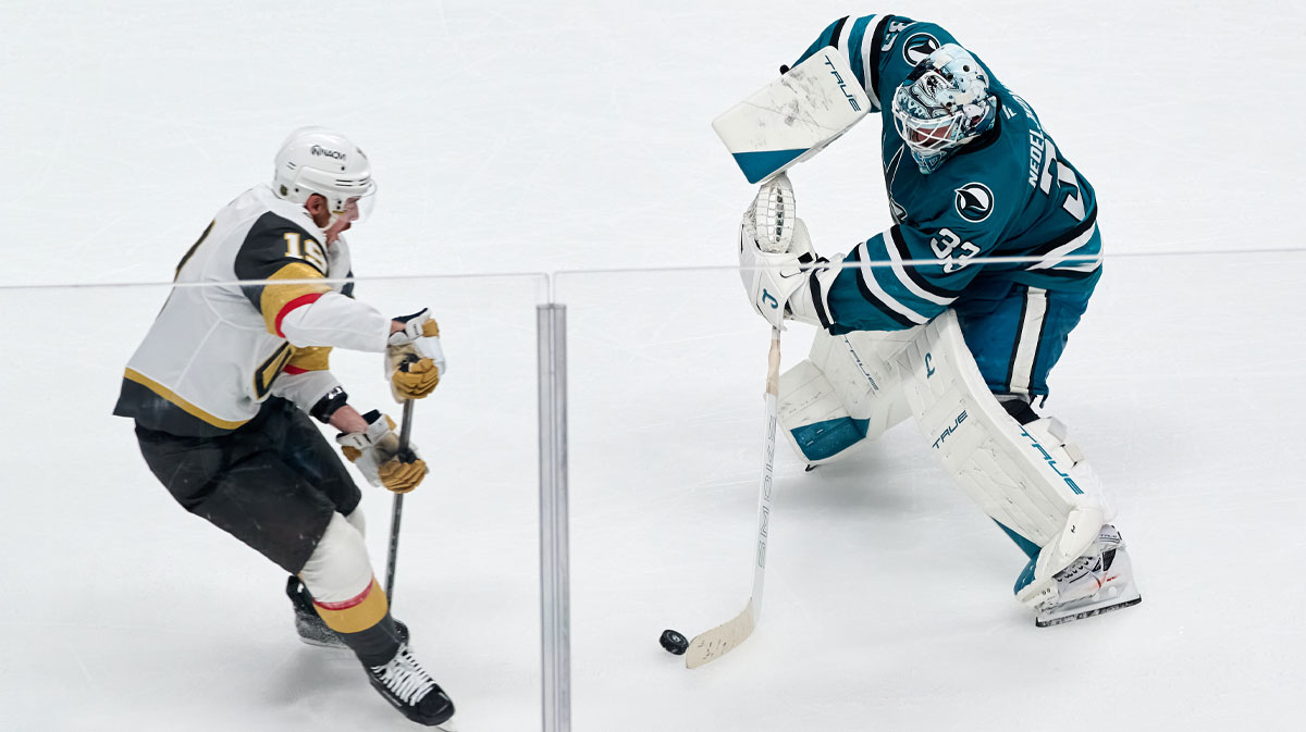 San Jose Sharks goaltender Alex Nedeljkovic (33) misplays the puck against Vegas Golden Knights right wing Reilly Smith (19) during the overtime period at SAP Center at San Jose.