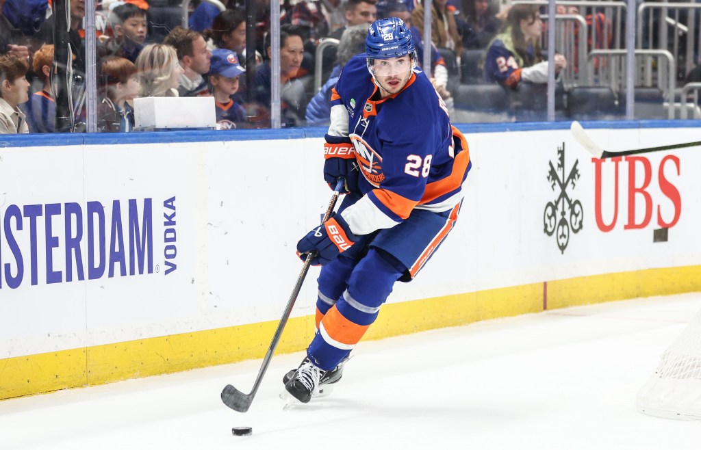 Alexander Romanov, who is battling an upper-body injury, skates with the puck during the Islanders' win over the Oilers on Oct. 16, 2025.
