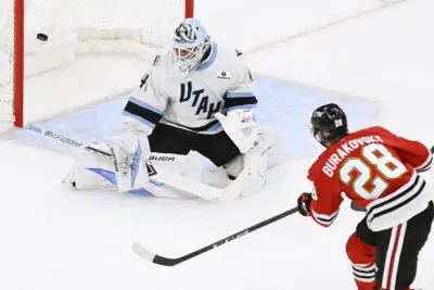 Oct 13, 2025; Chicago, Illinois, USA; Chicago Blackhawks left wing Andre Burakovsky (28) scores past Utah Mammoth goaltender Vitek Vanecek (41) during the third period at United Center.
