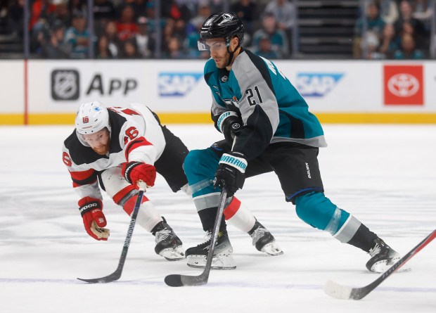 San Jose Sharks' Alexander Wennberg (21) controls the puck against...