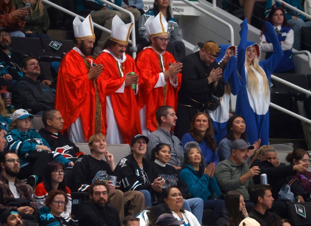 Hockey fans try to get on the Jumbotron during the...