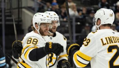 Boston Bruins right wing David Pastrnak (88), center Pavel Zacha (18) and center Elias Lindholm (28) celebrate after a goal against the Utah Mammoth during the first period of an NHL hockey game Sunday, Oct. 19, 2025, in Salt Lake City.