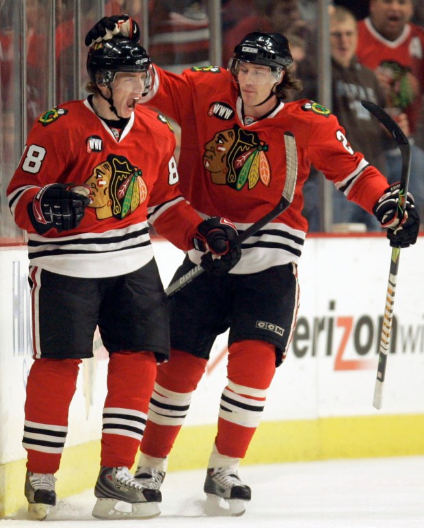 Chicago Blackhawks' right winger Patrick Kane, left, celebrates with teammate Duncan Keith after scoring his first NHL goal against the Colorado Avalanche during the first period on Oct. 19, 2007, in Chicago. (Nam Y. Huh/AP)