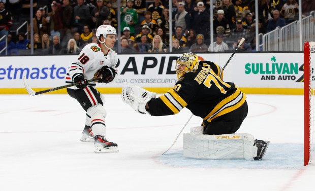 Bruins goalie Joonas Korpisalo makes a save against the Blackhawks' Connor Bedard in overtime Thursday, Oct. 9, 2025 in Boston. (Rich Gagnon/Getty Images)