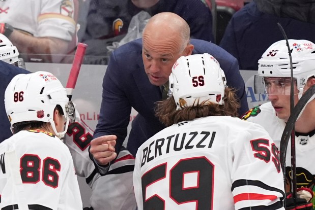 Chicago Blackhawks head coach Jeff Blashill talks to players during the third period of an NHL hockey game against the Florida Panthers, Tuesday, Oct. 7, 2025, in Sunrise, Fla. (AP Photo/Rebecca Blackwell)
