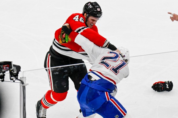 Blackhawks defenseman Louis Crevier, left, and Canadiens defenseman Kaiden Guhle fight during the second period Saturday, Oct. 11, 2025, at the United Center. (Matt Marton/AP)