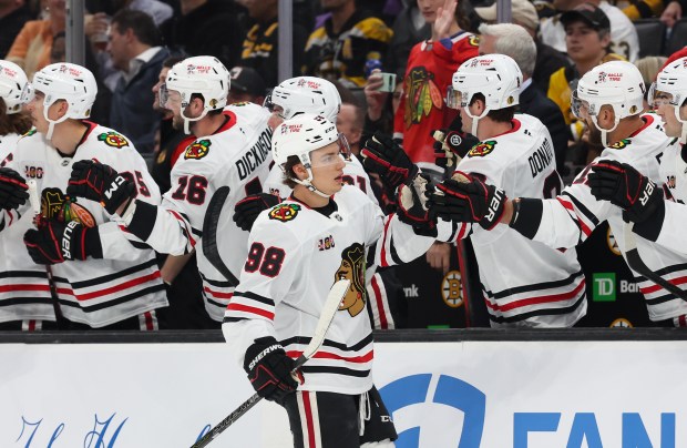 Blackhawks center Connor Bedard (98) celebrates his goal with teammates during the first period against the Bruins on Oct. 9, 2025, in Boston. (Rich Gagnon/Getty Images)