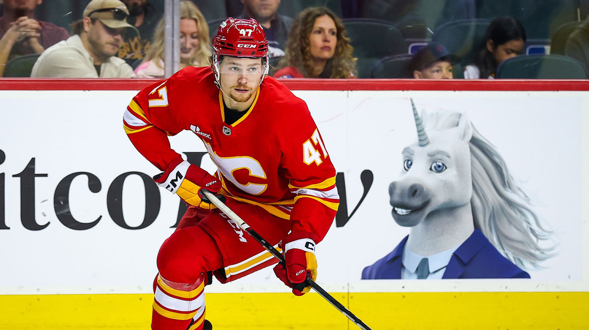 Calgary Flames center Connor Zary (47) controls the puck against Vancouver Canucks left wing Kiefer Sherwood (44) during the second period at Scotiabank Saddledome. 