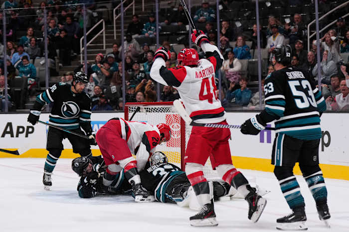 Carrier, Robinson score late in 2nd period and Hurricanes beat Sharks 5-1 to improve to 3-0