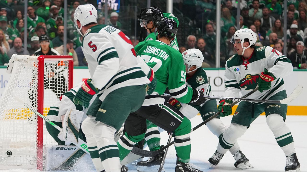 A shot by Dallas Stars center Wyatt Johnston (53) enters the net of Minnesota Wild goaltender Filip Gustavsson for a goal during the first period of an NHL hockey game Tuesday, Oct. 14, 2025, in Dallas. (AP Photo/Julio Cortez)