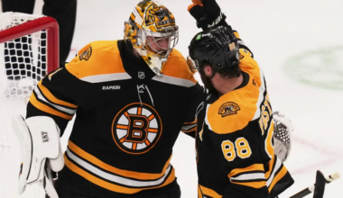 Jeremy Swayman and David Pastrnak celebrating a win