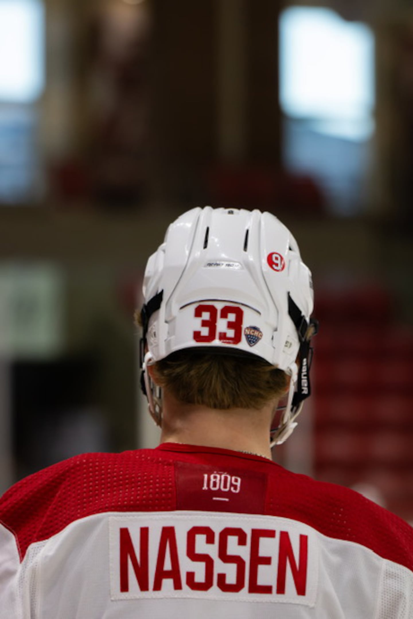 A No. 9 sticker in honor of Rick Kuraly is shown on the helmet of Miami hockey player Casper Nassen, who is a Bruins draft pick.