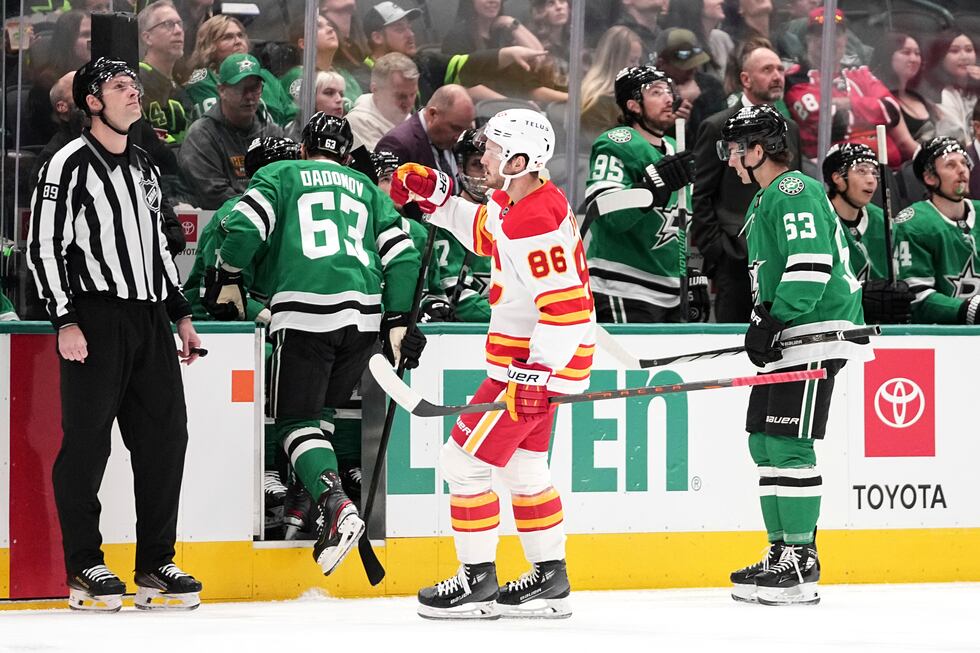 Calgary Flames' Joel Farabee (86) skates to the bench to celebrate his goal as Dallas Stars'...