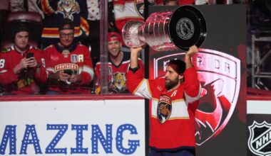 Panthers defenseman Aaron Ekblad holds up the Stanley Cup as he arrives on the ice as Florida raised another Stanley Cup banner before Tuesday's season opener against the Blackhawks.