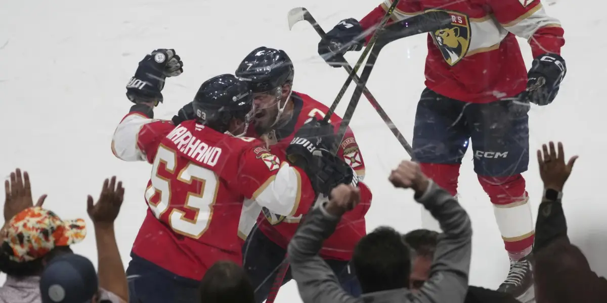 Marchand celebrating his OT game-winning goal with Kulikov. (AP Photo/Marta Lavandier)