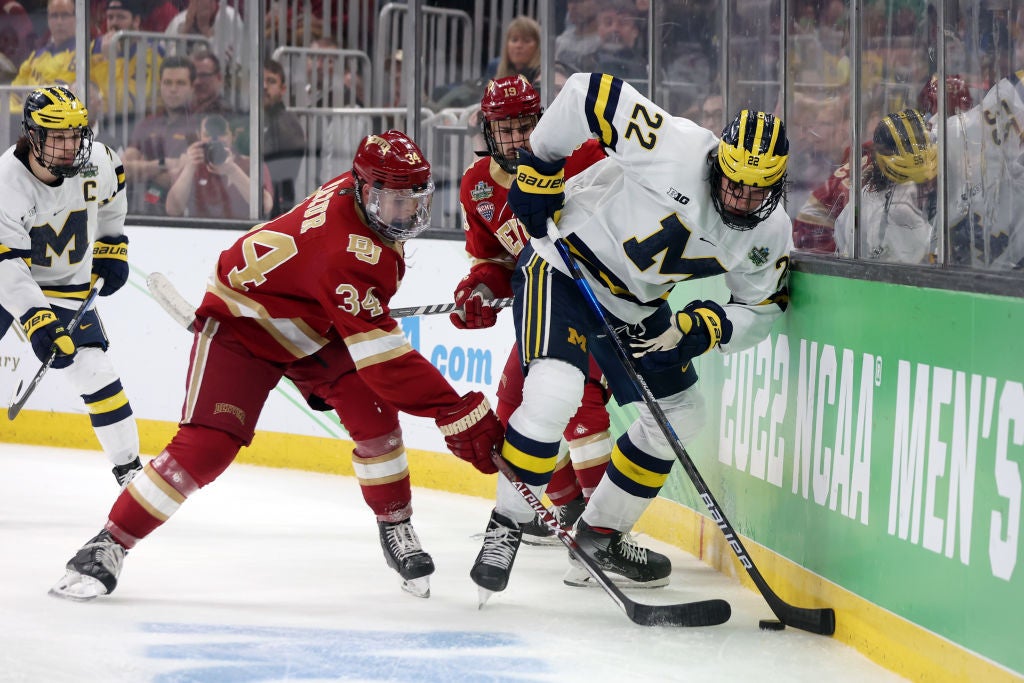 Carter Mazur #34 of the Denver Pioneers defends Owen Power #22 of the Michigan Wolverines during the Frozen Four semifinal game. (Maddie Meyer/Getty Images)
