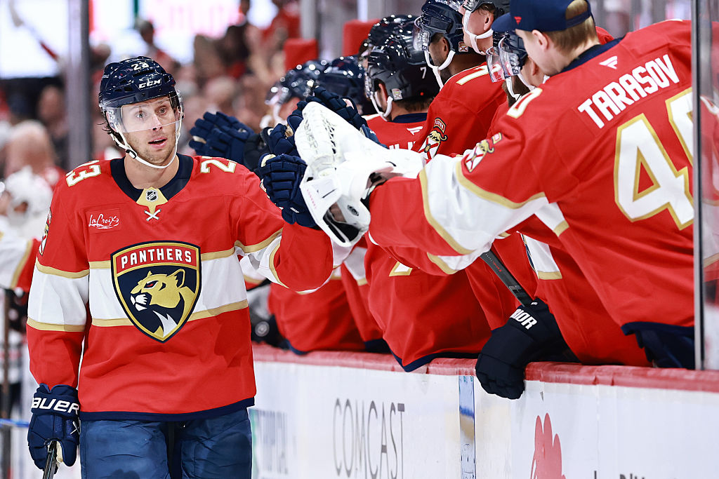 Carter Verhaeghe #23 of the Florida Panthers high fives teammates after scoring against the Chicago Blackhawks during the first period at Amerant Bank Arena on October 07, 2025 in Sunrise, Florida.