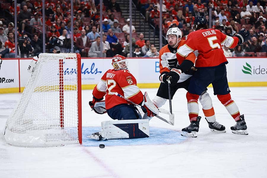 SUNRISE, FLORIDA - OCTOBER 09: Noah Cates #27 of the Philadelphia Flyers crashes the net against Aaron Ekblad #5 of the Florida Panthers during the third period at Amerant Bank Arena on October 09, 2025 in Sunrise, Florida.