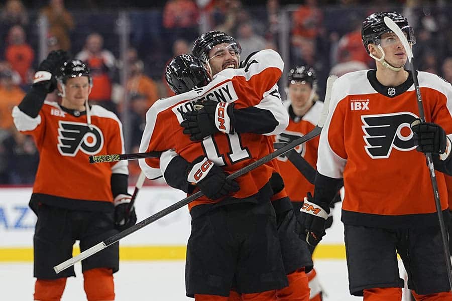 PHILADELPHIA, PENNSYLVANIA - OCTOBER 18: Noah Cates #27 of the Philadelphia Flyers hugs Travis Konecny #11 after scoring the game winning goal in overtime against the Minnesota Wild at Xfinity Mobile Arena on October 18, 2025 in Philadelphia, Pennsylvania. The Flyers defeated the Wild 2-1 in overtime.
