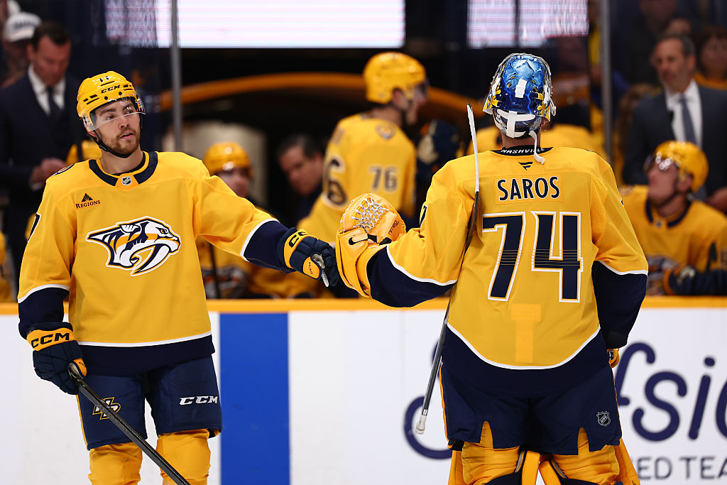 NASHVILLE, TENNESSEE - OCTOBER 23: goaltender Juuse Saros #74 high-fives center Tyson Jost #17 of the Nashville Predators in the first period against the Vancouver Canucks on October 23, 2025 at Bridgestone Arena in Nashville. (Photo by Casey Gower/NHLI via Getty Images)
