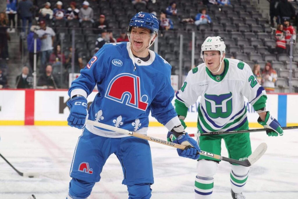 Avalanche's Zakhar Bardakov and Hurricanes' Alexander Nikishin skate prior to the game at Ball Arena on Oct. 23, 2025.