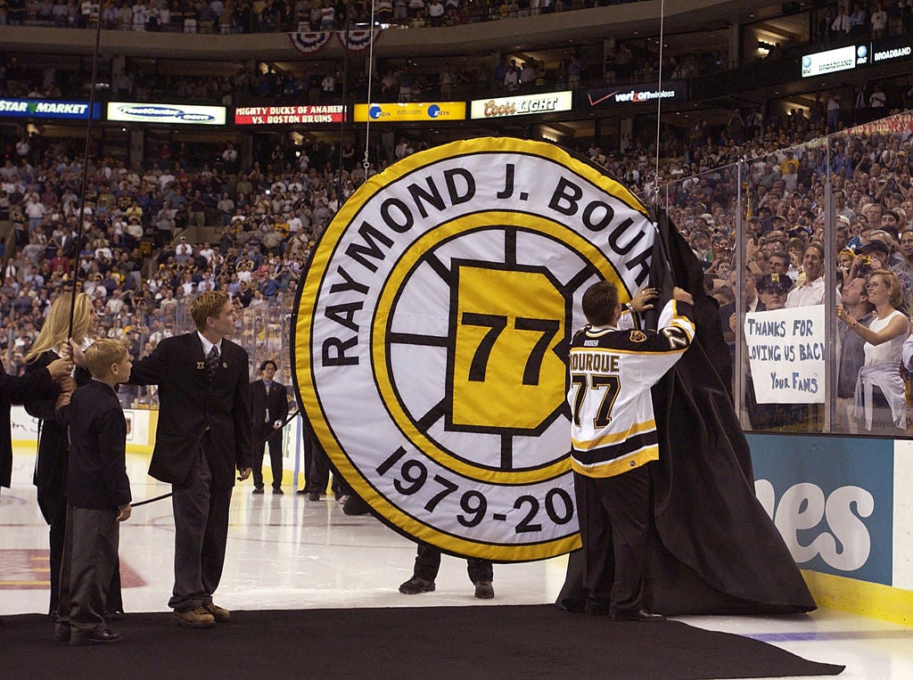 Ray Bourque #77 of the Boston Bruins uncovers his number during a ceremony in which the Bruins retired his number before their home opener against the Mighty Ducks of Anaheim. (Ezra Shaw/ALLSPORT)