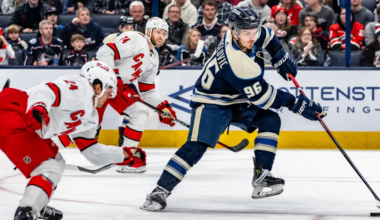 Jack Roslovic with the puck trying to get through Carolina's defense