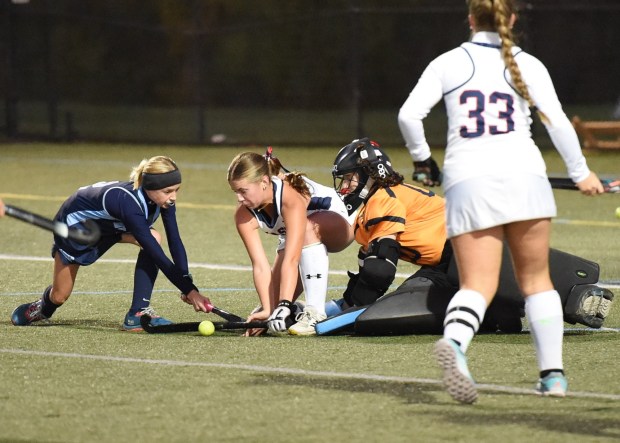 North Penn's Cecilia Lewis, 2, and Central Bucks East's Kate McCauley, 8, and goalkeeper Cam Puhalla, 00, vie for the ball during their District 1-3A first round game on Monday, Oct. 20, 2025. (Mike Cabrey/MediaNews Group)