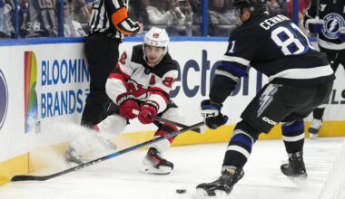 New Jersey Devils center Jack Hughes (86) slips the puck away from Tampa Bay Lightning defenseman Erik Cernak (81) during the first period of an NHL hockey game Saturday, Nov. 16, 2024, in Tampa, Fla. (AP Photo/Chris O'Meara)