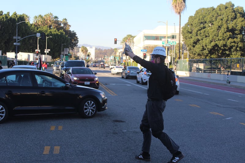 Protestor guiding traffic.