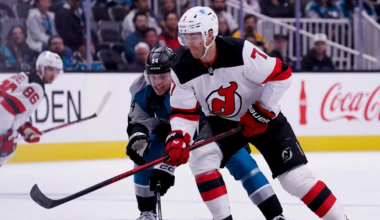 Dougie Hamilton fights for the puck against the San Jose Sharks.