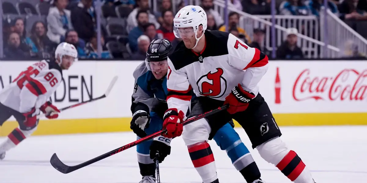 Dougie Hamilton fights for the puck against the San Jose Sharks.