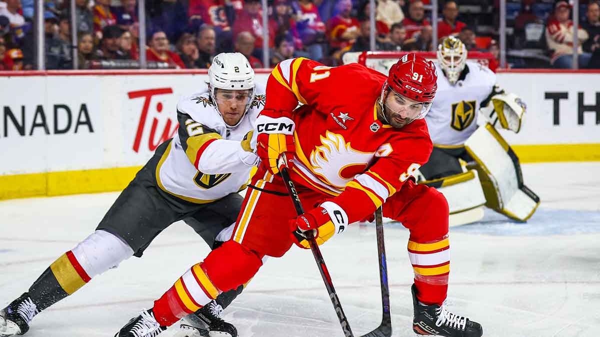 Calgary Flames center Nazem Kadri (91) and Vegas Golden Knights defenseman Zach Whitecloud (2) battles for the puck during the second period at Scotiabank Saddledome. 