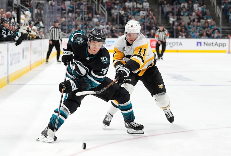 SAN JOSE, CALIFORNIA - OCTOBER 18: Filip Hallander #11 of the Pittsburgh Penguins and William Eklund #72 of the San Jose Sharks battles for control of the puck in the third period at SAP Center on October 18, 2025 in San Jose, California. (Photo by Thearon W. Henderson/Getty Images)