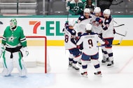 Columbus Blue Jackets players congratulate center Boone Jenner (38) on his first period goal...