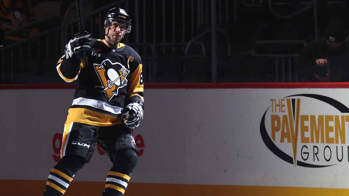 Evgeni Malkin in Pittsburgh Penguins gear with an arrow pointing to him wearing Florida Panthers gear. Amerant Bank Arena as the background image.