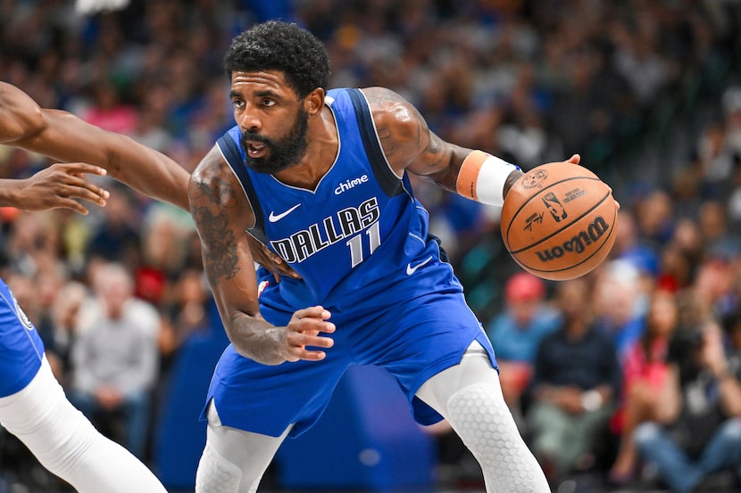 Dallas Mavericks guard Kyrie Irving (11) drives in the second half of an NBA basketball game...