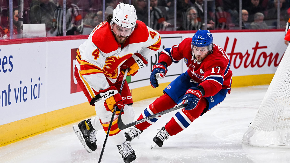 Calgary Flames defenseman Rasmus Andersson (4) plays the puck against Montreal Canadiens right wing Josh Anderson (17) during the second period at Bell Centre