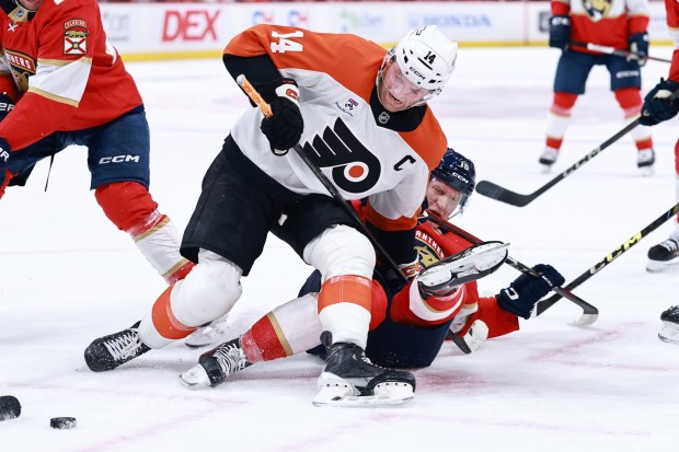 Anton Lundell of the Florida Panthers. bottom, battles Sean Couturier of the Philadelphia Flyers during the third period at Amerant Bank Arena on Oct. 09, 2025 in Sunrise, Florida. (Photo by Carmen Mandato/Getty Images)