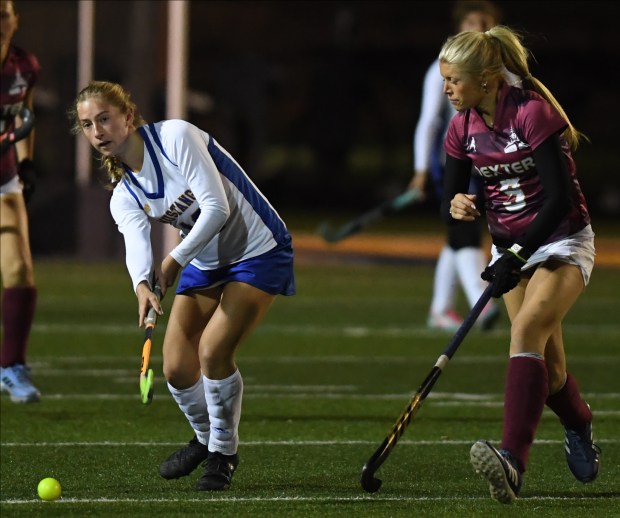 Bloomfield Hills Marian's Clair Dauer (L) clears the ball from...
