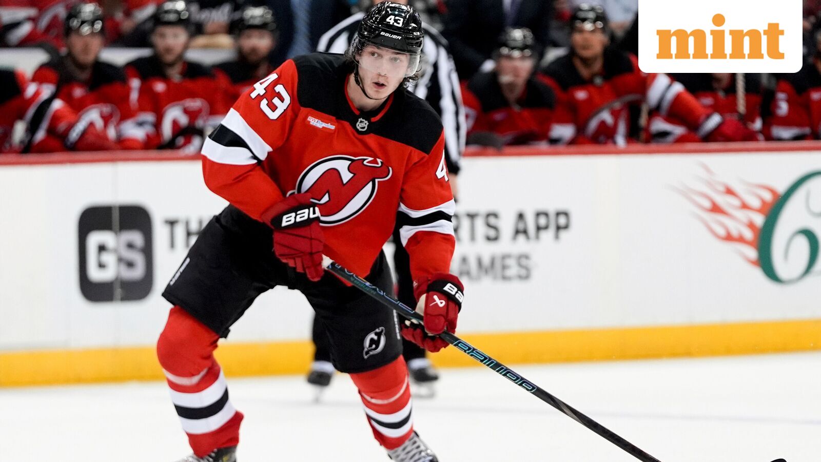 New Jersey Devils defenseman Luke Hughes skates with the puck during the second period of an NHL hockey game against the Minnesota Wild (file photo)