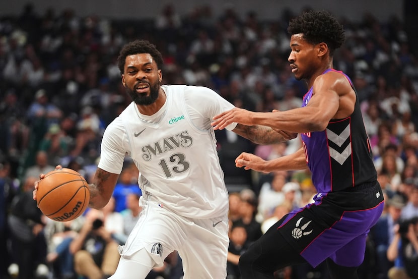 Dallas Mavericks forward Naji Marshall (13) works against Toronto Raptors guard Ochai...