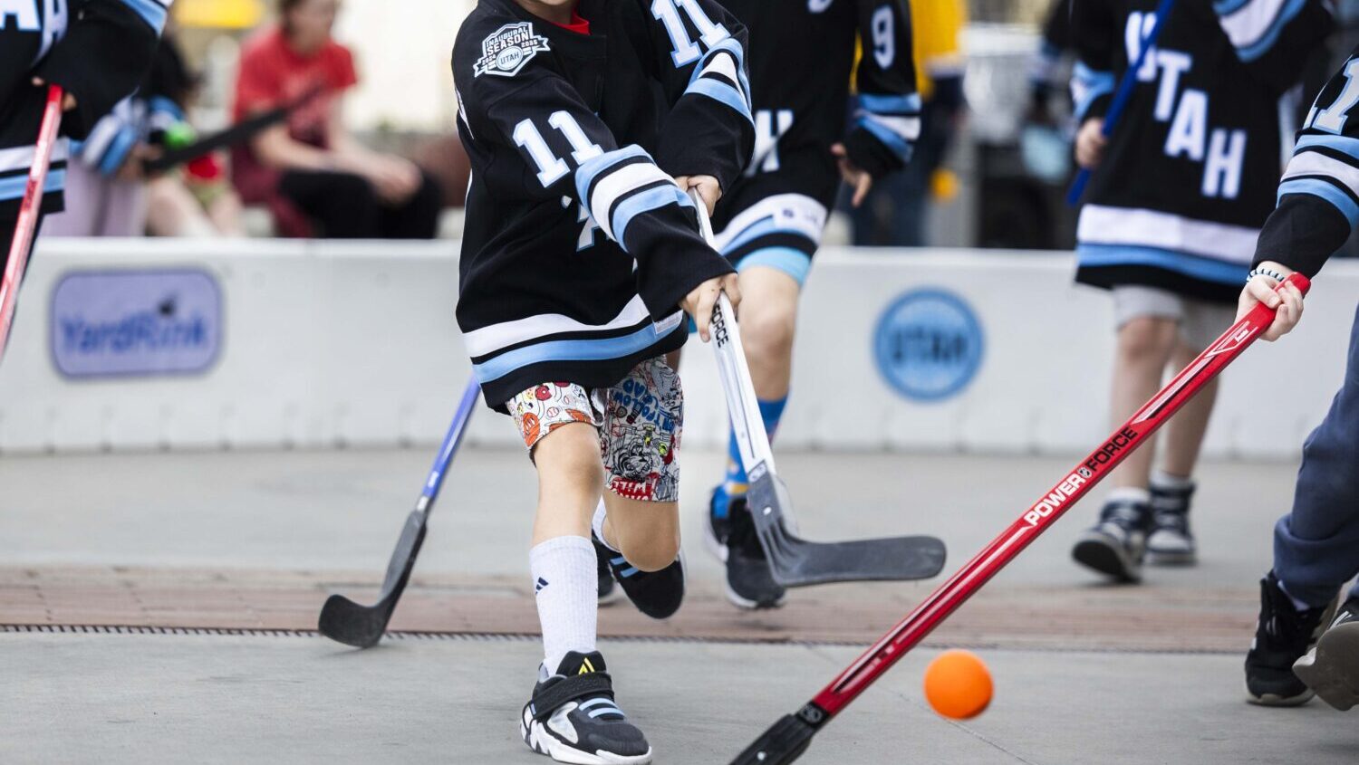 Landon Herzog, 9, shoots the ball at the goal while playing street hockey during the Utah Hockey Cl...
